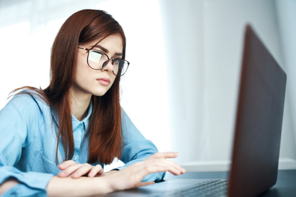 woman student sitting in laptop emotions work learning